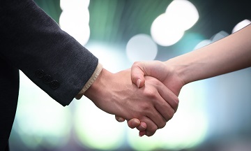 Handshake in business jacket
