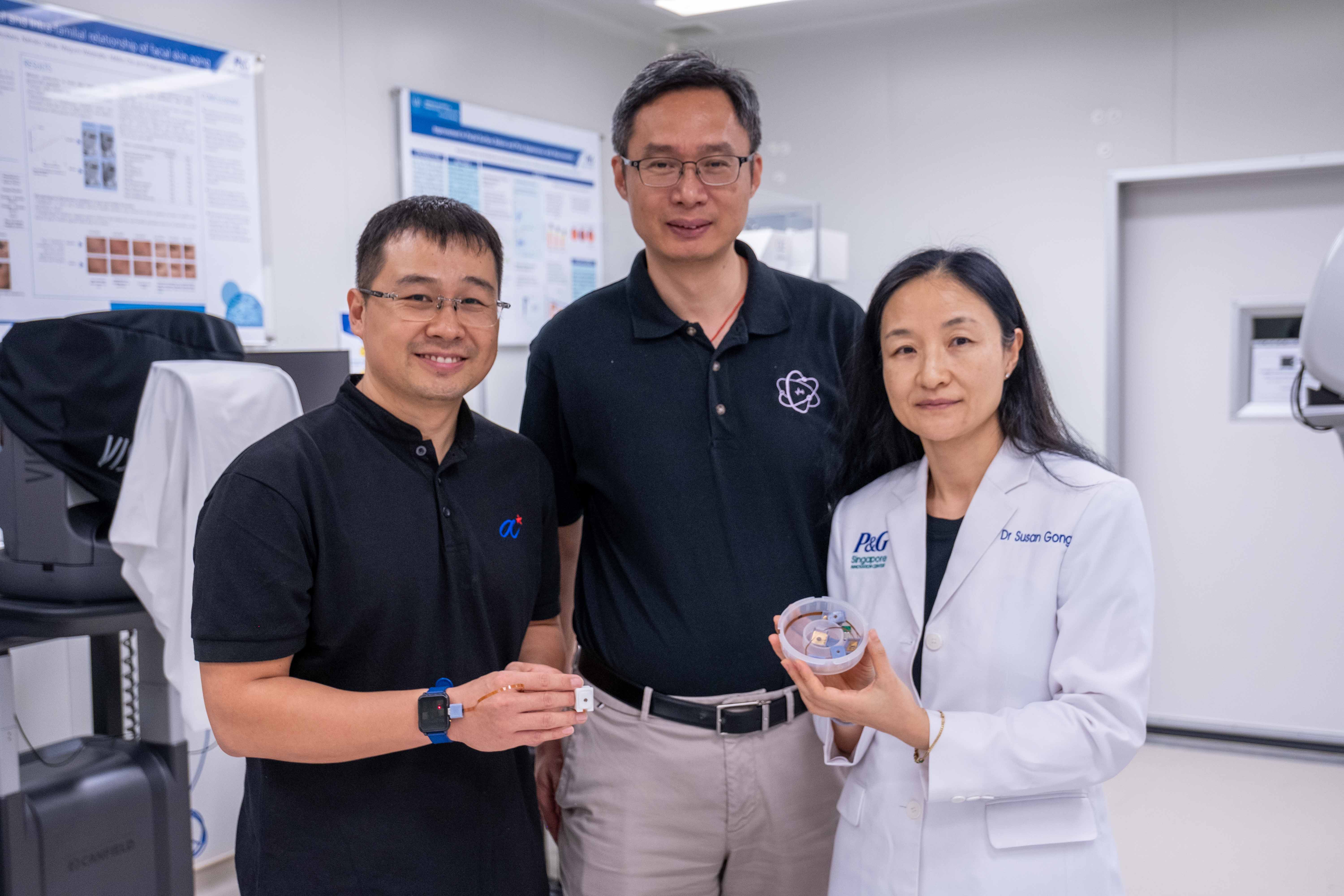 Dr Liu Zhihua, Prof Chen Xiaodong and Dr Susan Gong holding the HapSense device
