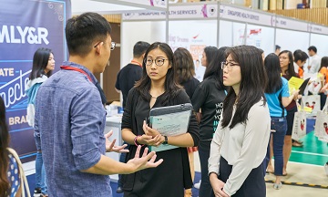 Students at career fair talking to recruiter