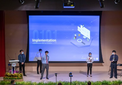 A group of students presenting their pitch on stage