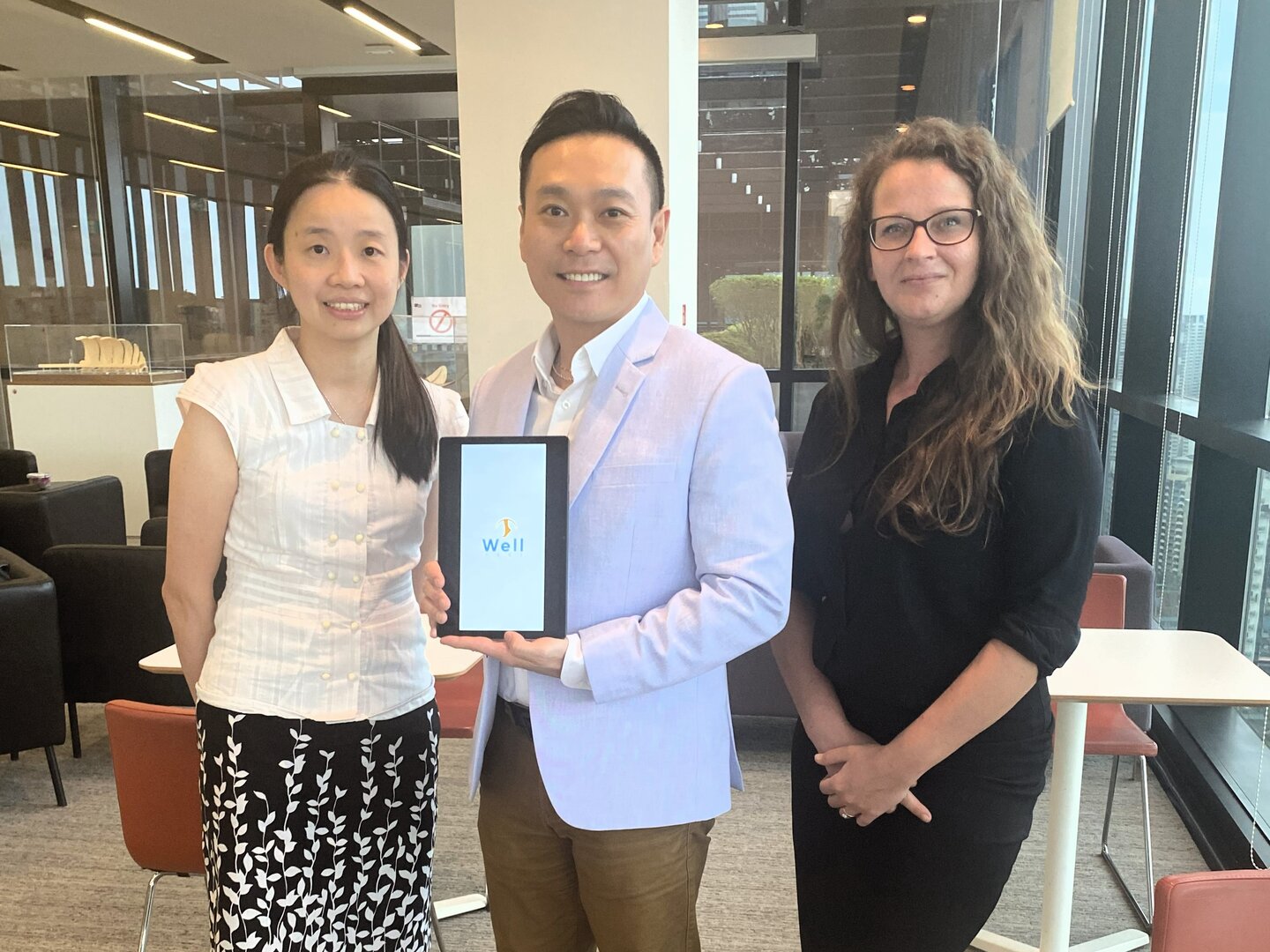 Tan Tock Seng Hospital Senior Consultant Dr Liew Huiling, Assoc Prof Andy Ho Hau Yan, and Research Fellow Dr Anita Pienkowska, posing with the WellFeet app.