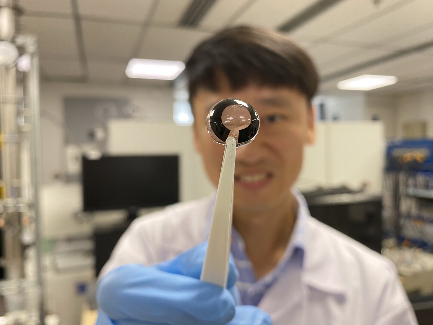 Associate Professor Lee Seok Woo, from NTU’s School of Electrical and Electronic Engineering (EEE) holding up the flexible battery that is as thin as a human cornea