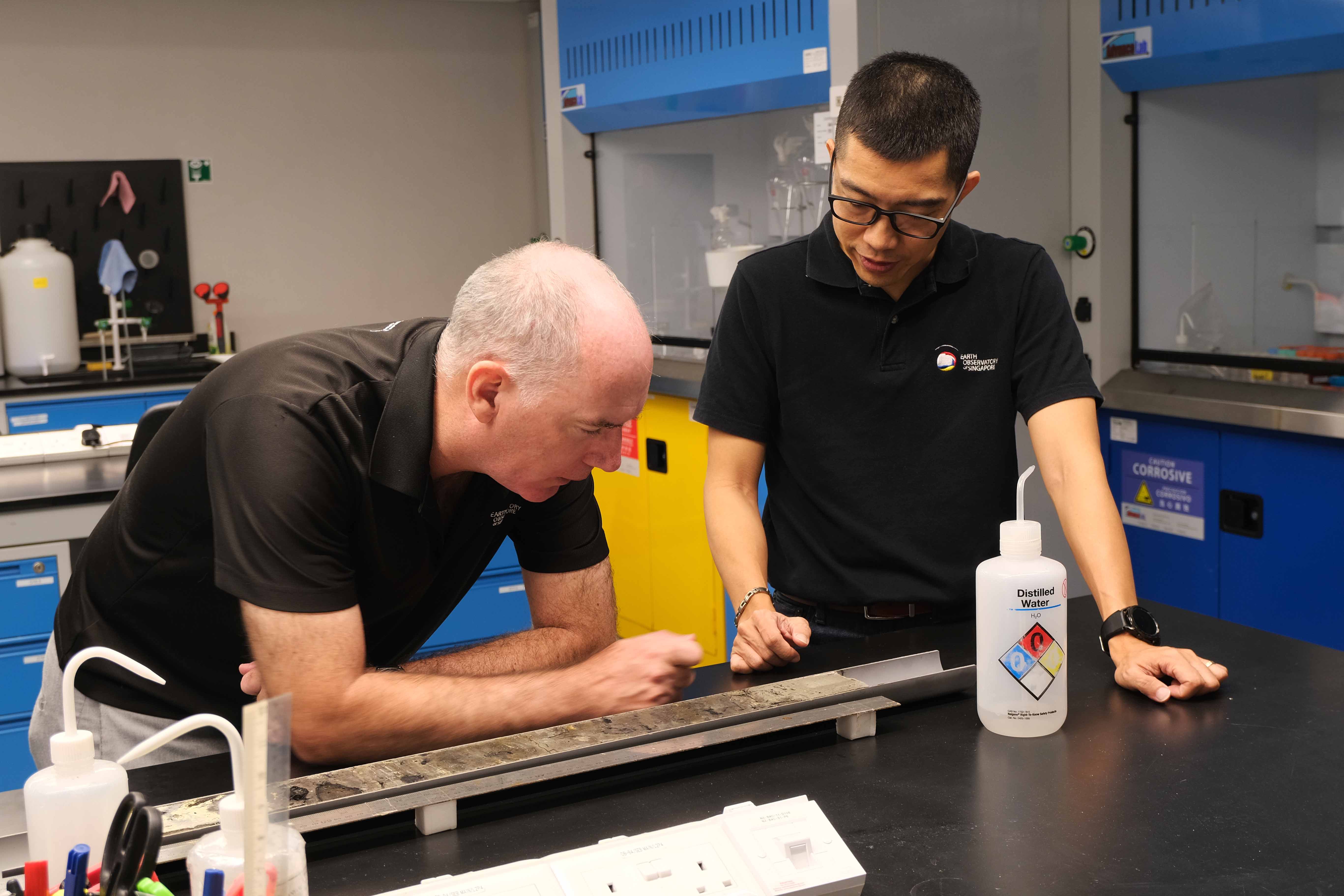 Professor Adam Switzer and Assistant Professor Stephen Chua examining a sediment core column