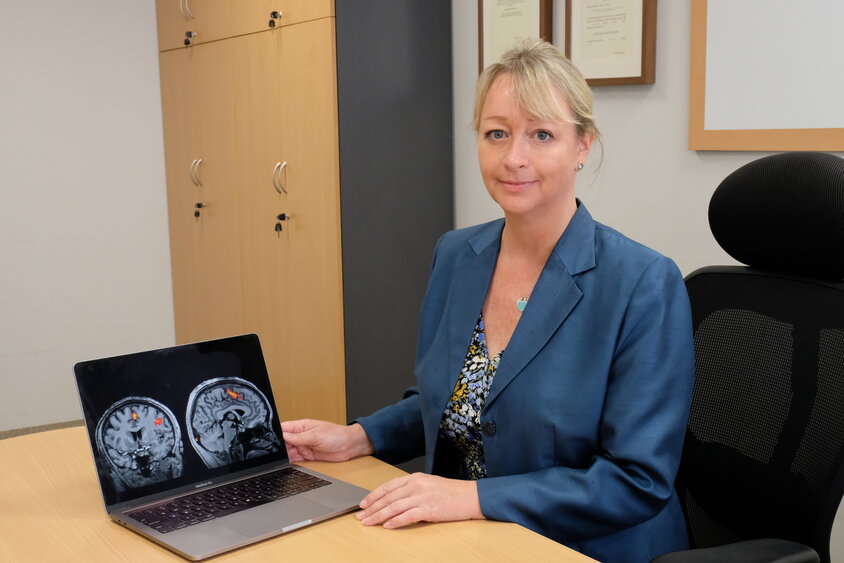 Professor Gemma Calvert with a laptop