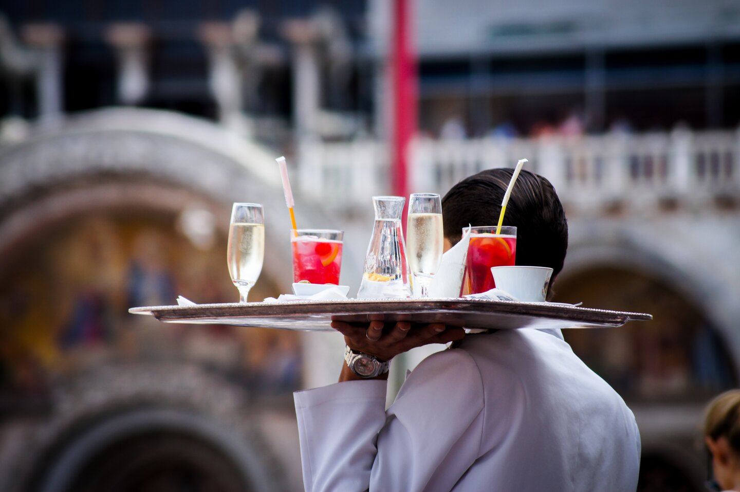 Waiter holding a tray of drinks
