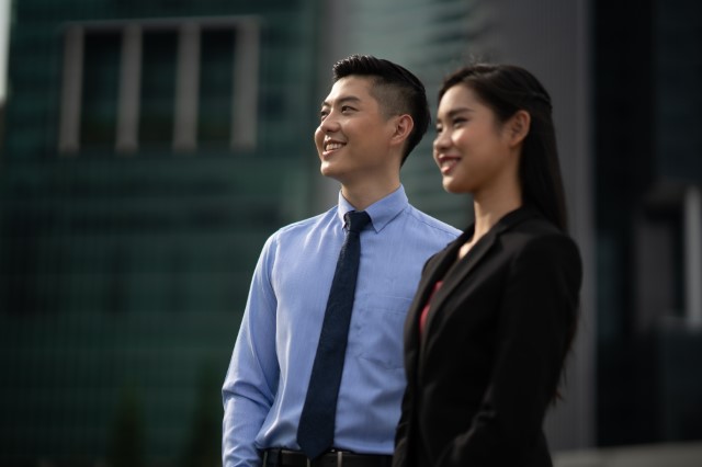 Two Nanyang Business School professional executives looking in the same direction