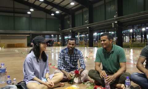 Sharing a light moment with migrant workers