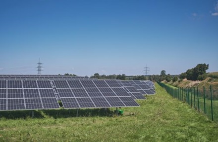 solar panels on green grass field.