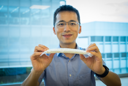 Assistant Professor Wang Yifan from NTU Singapore holding a stiffened nylon chain mail in a vacuum-packed envelope
