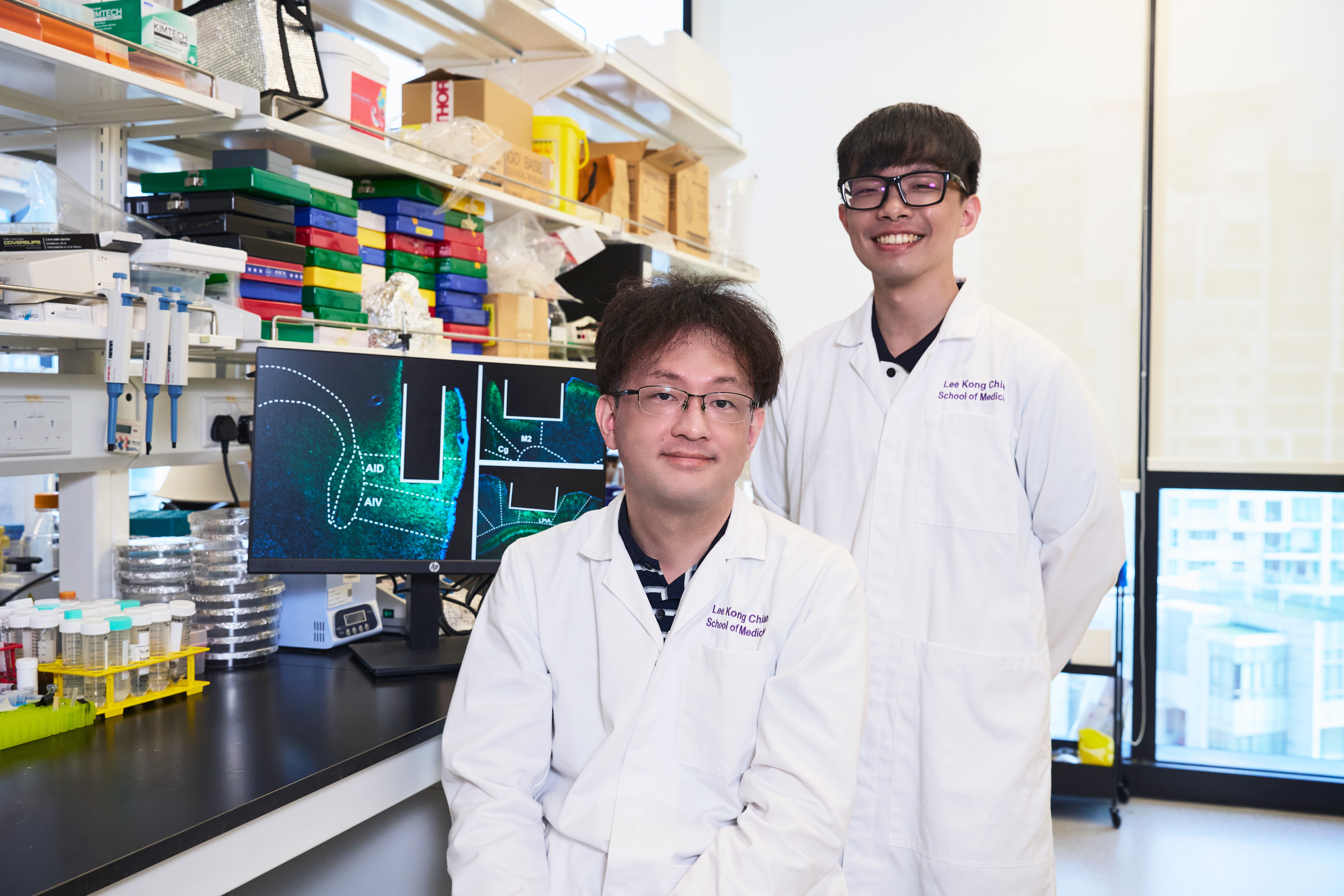 Asst Prof Tsukasa Kamigaki and Dr Malcom Ho in the laboratory