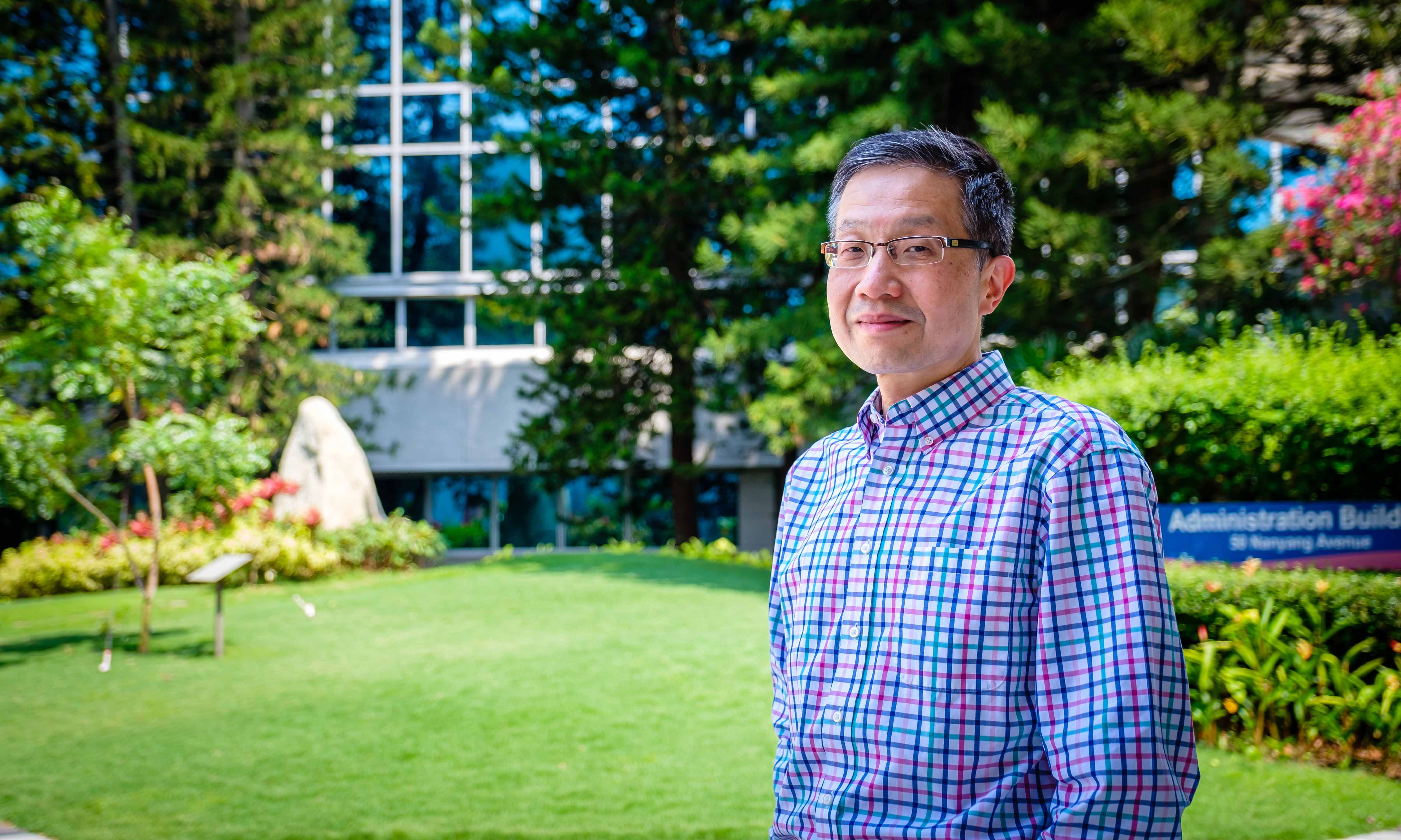 Prof Luke Ong in front of the NTU Administration building