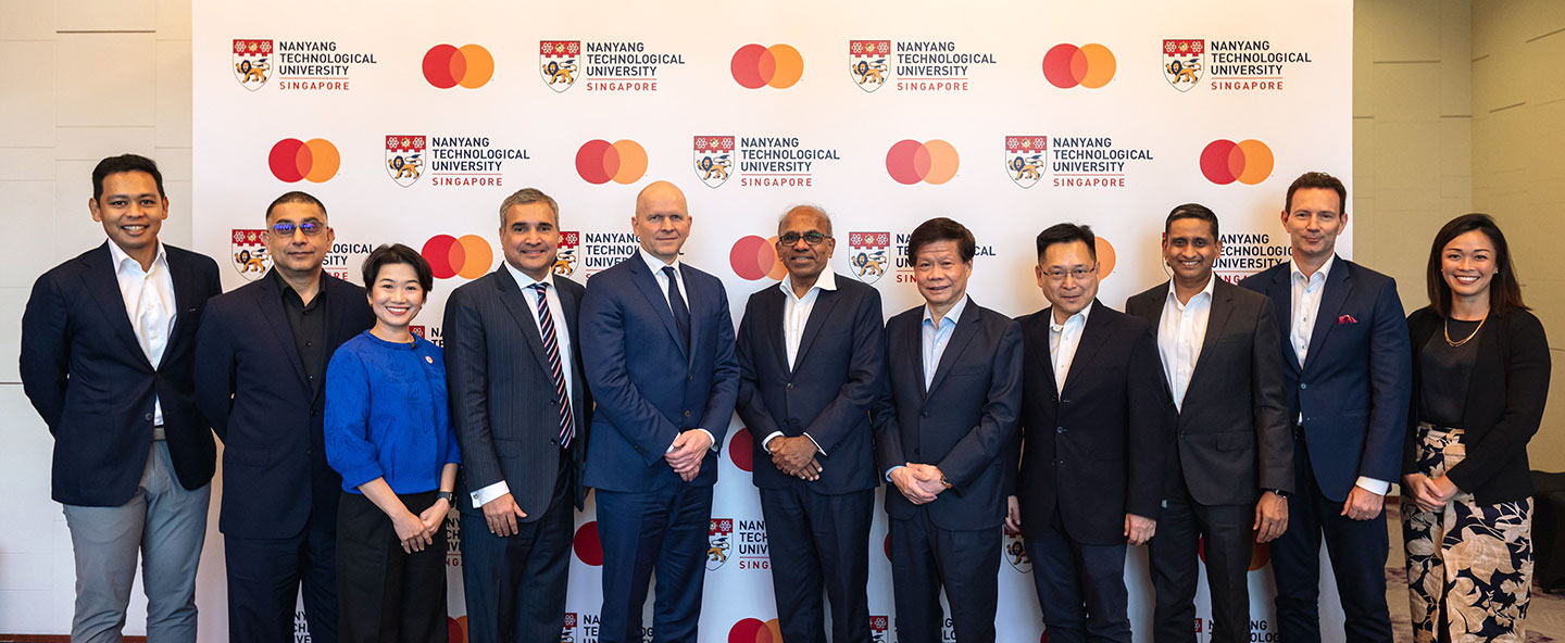 Photo of a group peoples standing infront of a Mastercard-NTU Joint Lab backdrop.