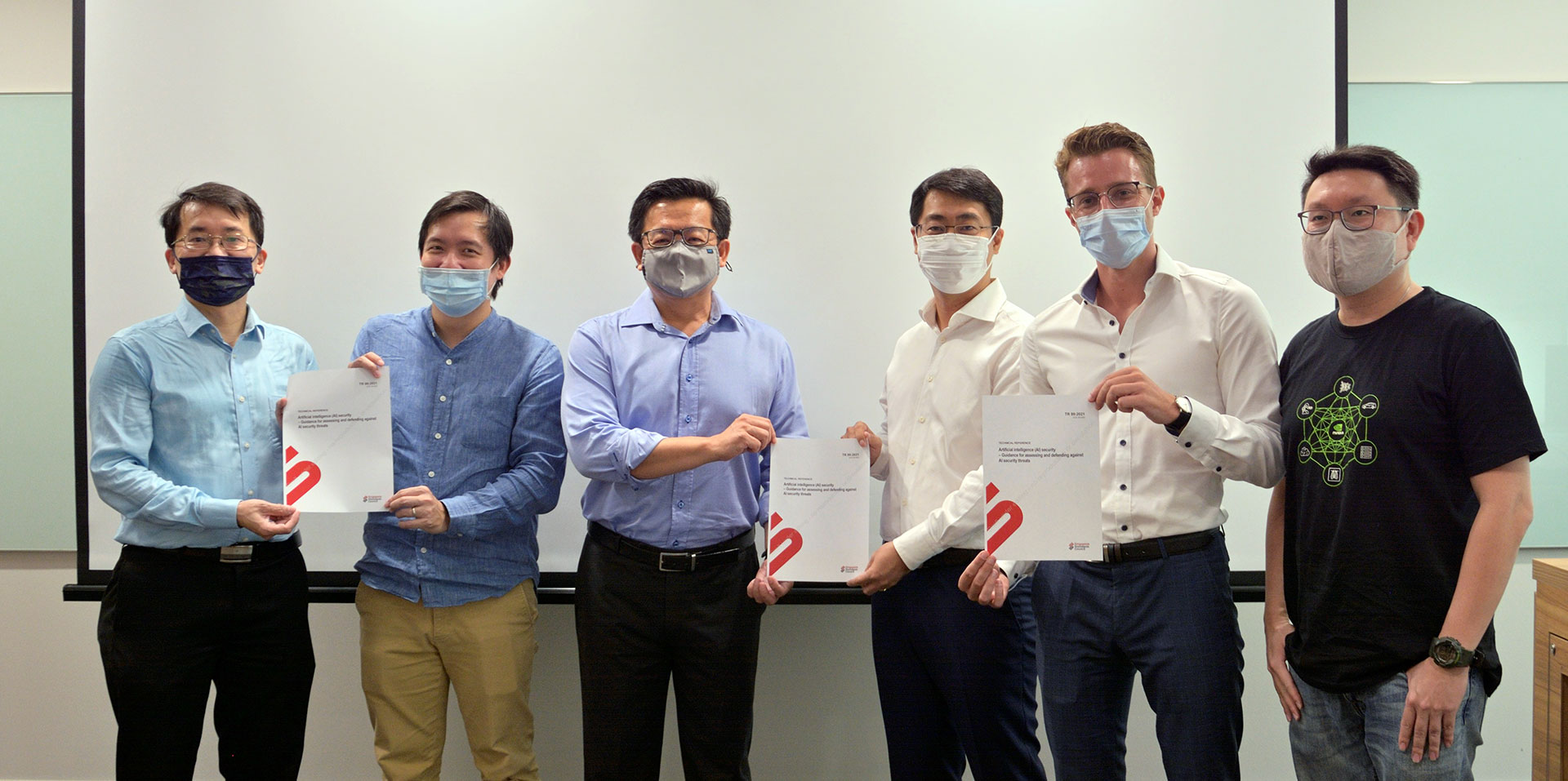 A group of men wearing mask are holding certificates.