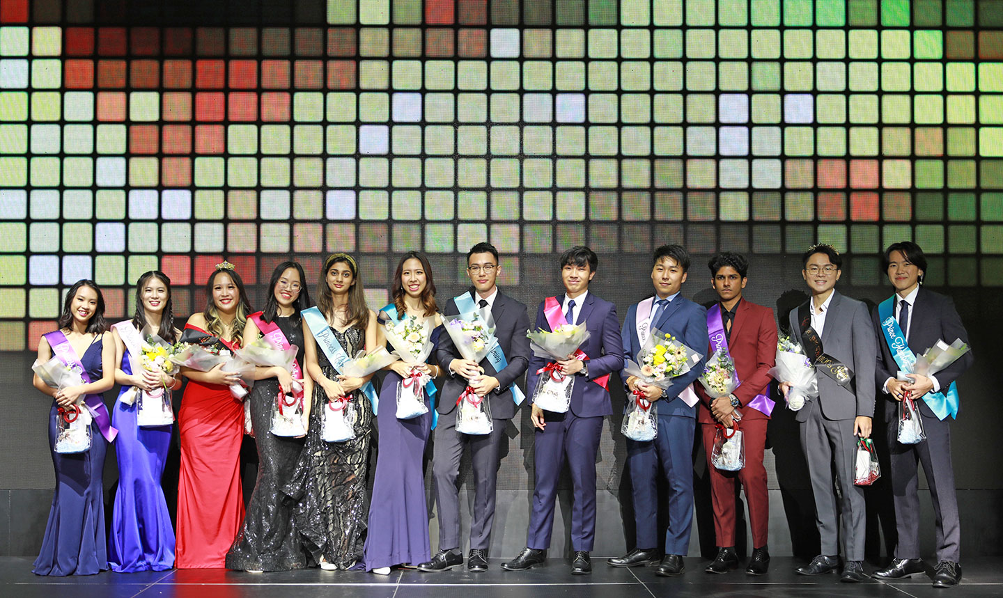 Photo of a group of students standing on the stage in a university pageant contest.