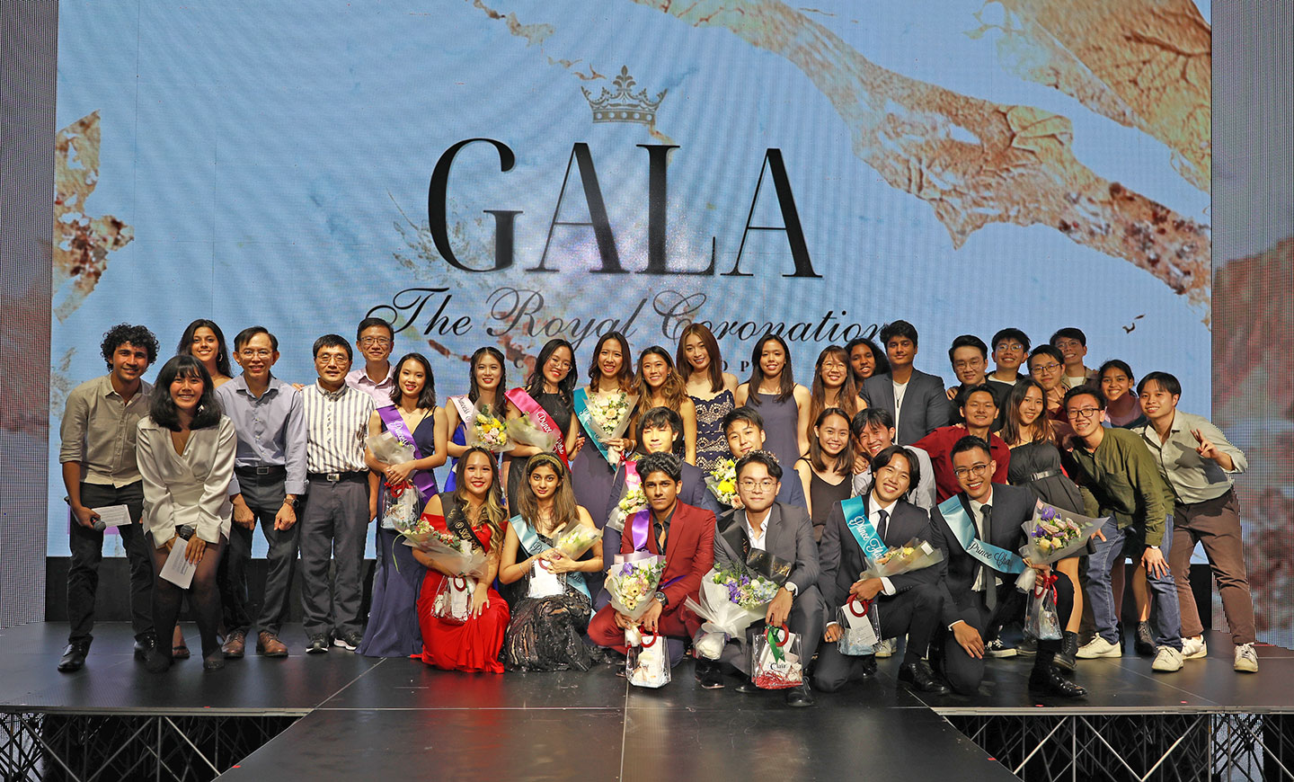 A group photo of students pageant contests and staff.