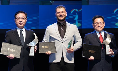 Thumbnail photo of 3 Professors holding their award and certificate on stage.