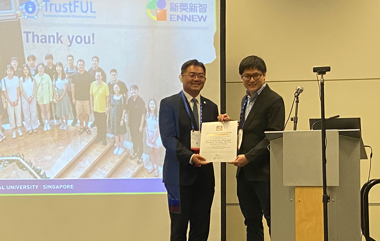 Photo of NAP Yu Han receiving Paper Award at AAAI 2024.