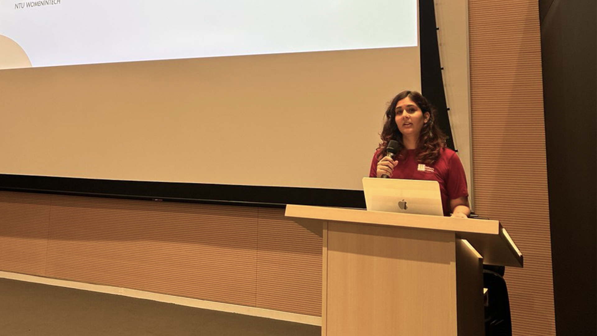 NTU CCDS student Katyayani Pande giving a talk at Women in Tech President's address