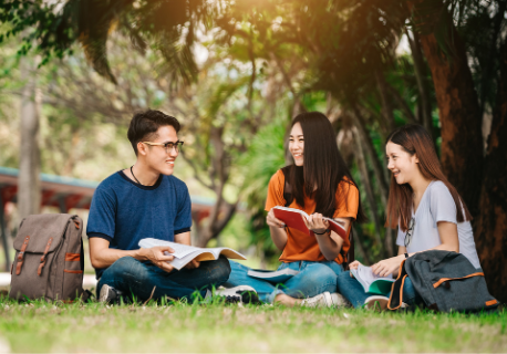 Three students are happily studying and smiling