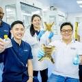 Group of researchers holding clinical grade collagen made from discarded bullfrog skin