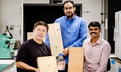 Group of researchers holding “fireproof” wood