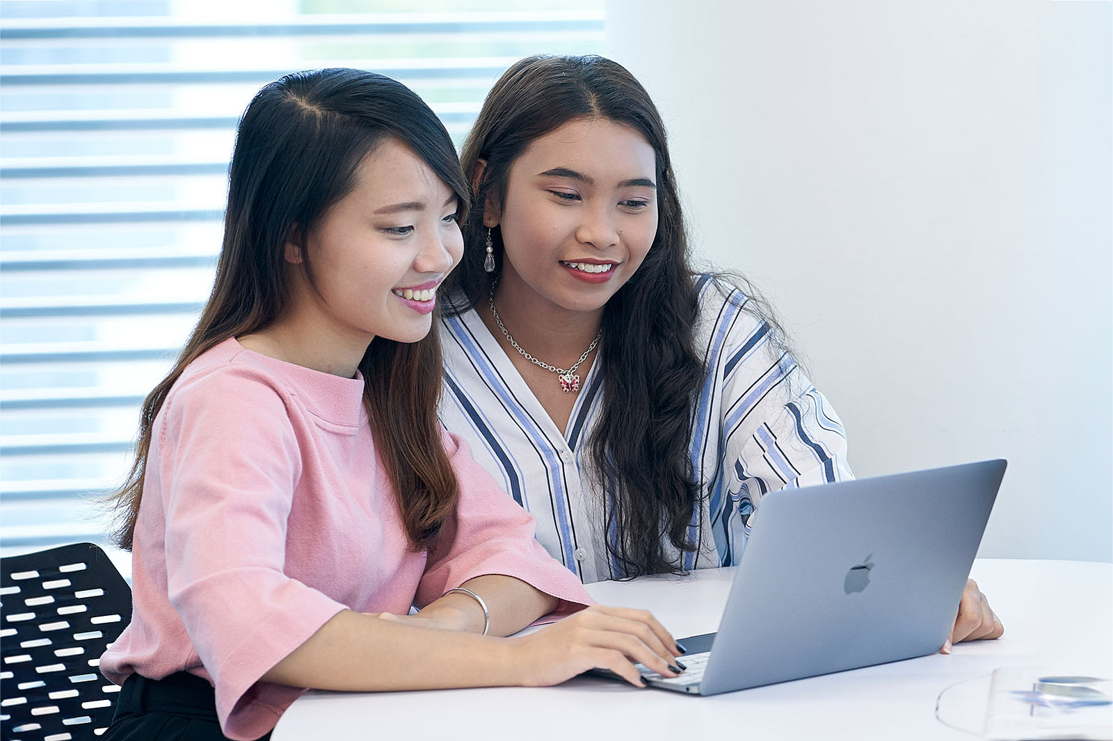 two-students-sharing-a-laptop