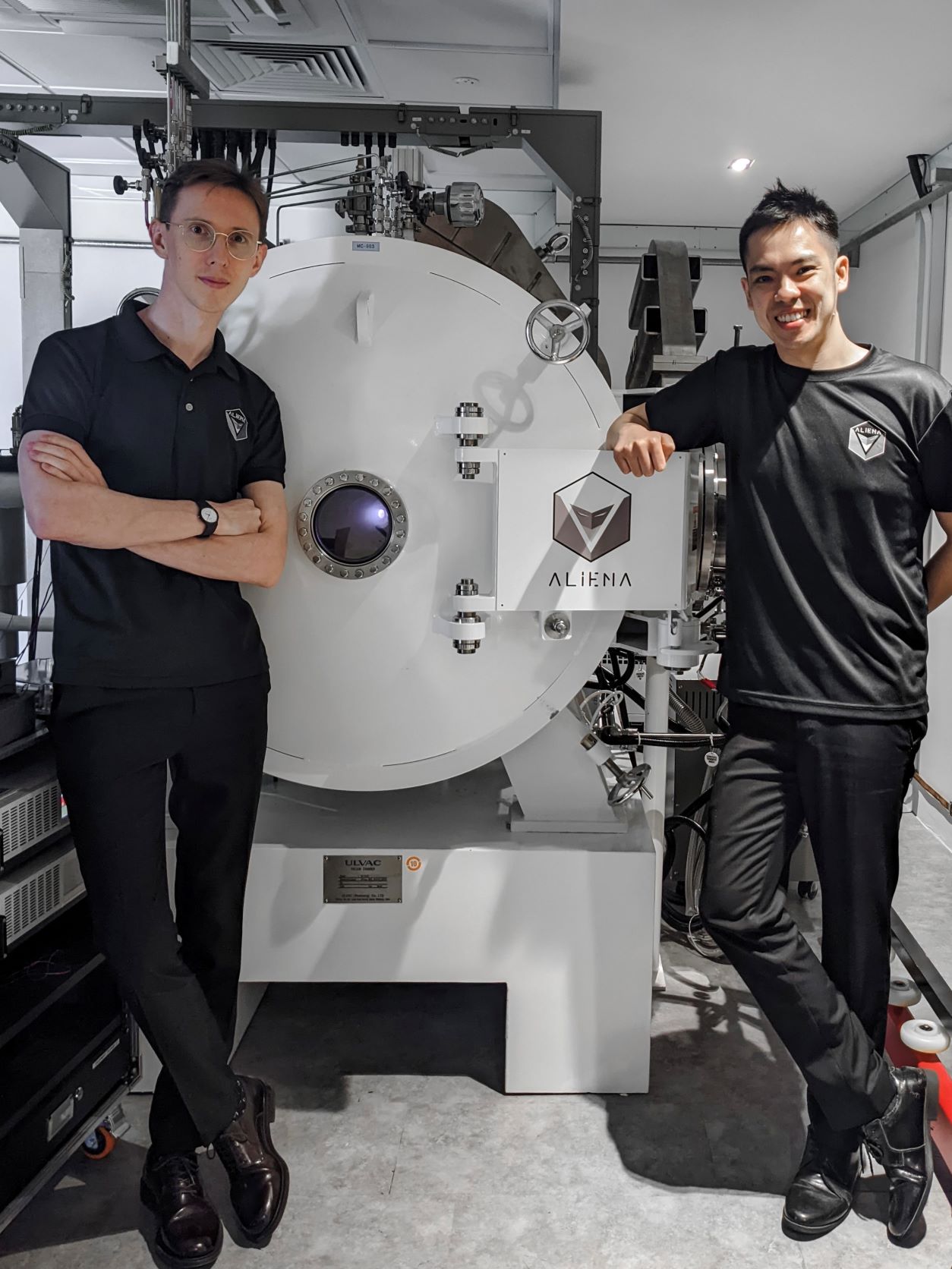 Co-founders Mr George Potrivitu and Dr Mark Lim in Aliena’s Jet Propulsion Test Facility, with the MUSIC engine firing in a simulated space environment chamber