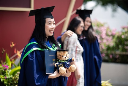 A female graduand posing for a photo at the NTU Convocation