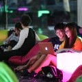 Students having a movie marathon while sitting on comfortable colourful beanbags