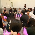 Participants sitting on coloured cubes having a discussion in a circle
