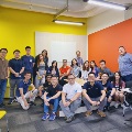 Students visiting a startup accelerator Social Collider. Space has yellow and orange walls.