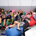 International students lying on beanbags having fun during a university bootcamp