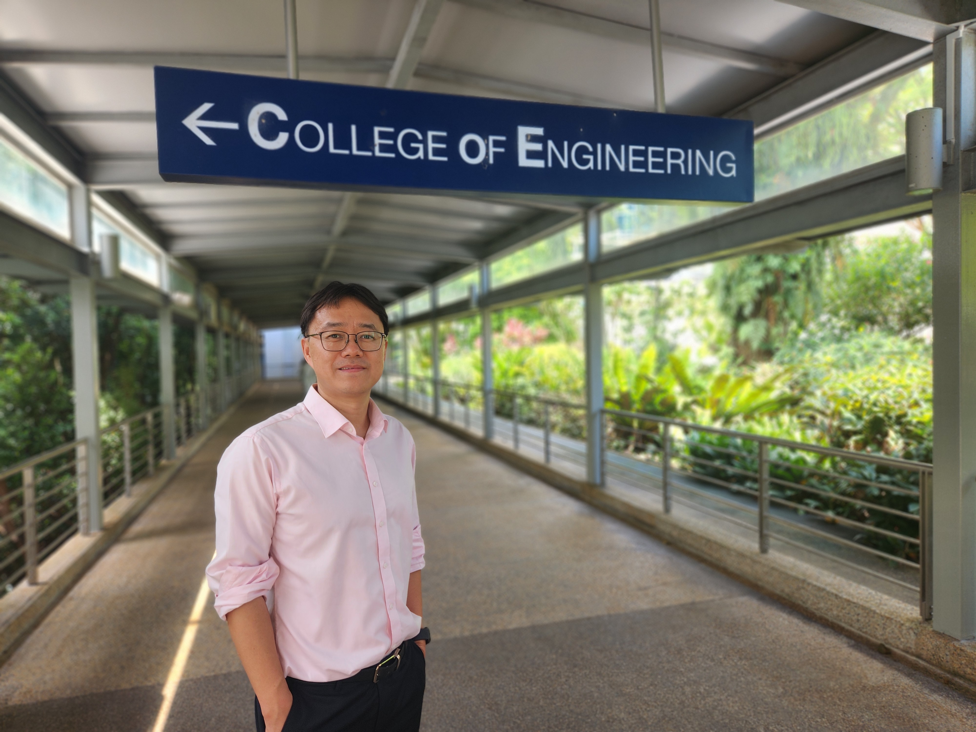 Professor Wang Qijie stands outside NTU College of Engineering