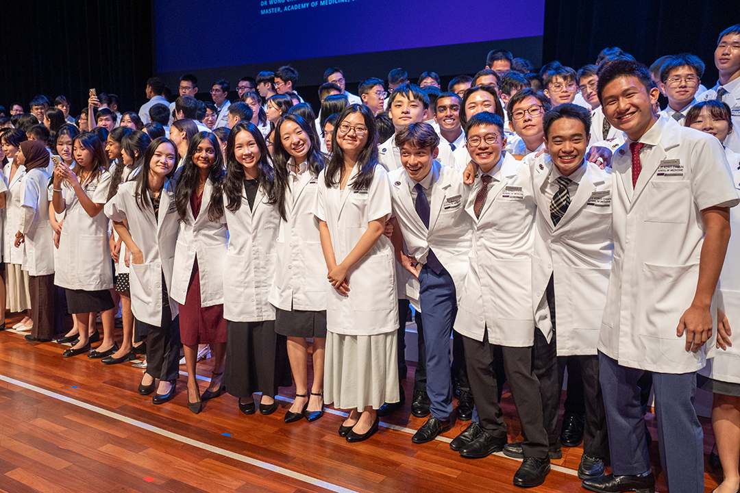 Happy faces at white coat group shot 2025