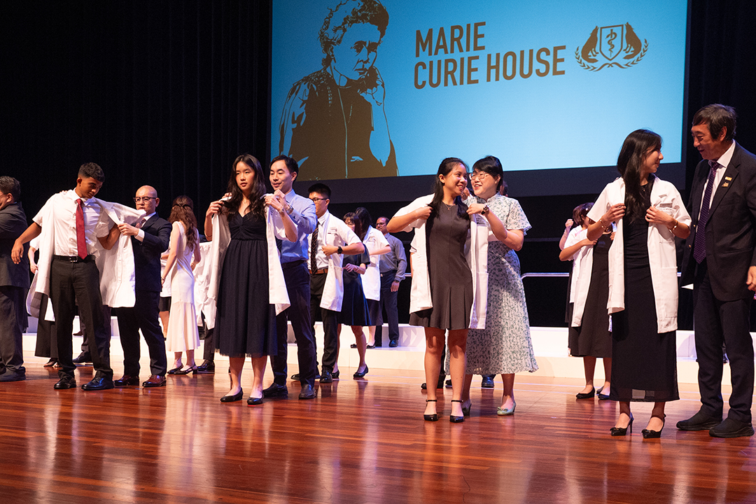 Students don white coat