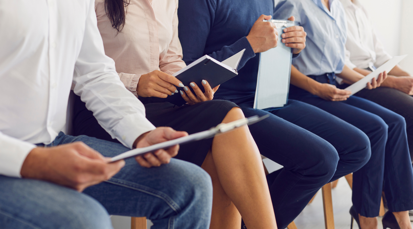 Young job candidates studying their notebooks and writing pads