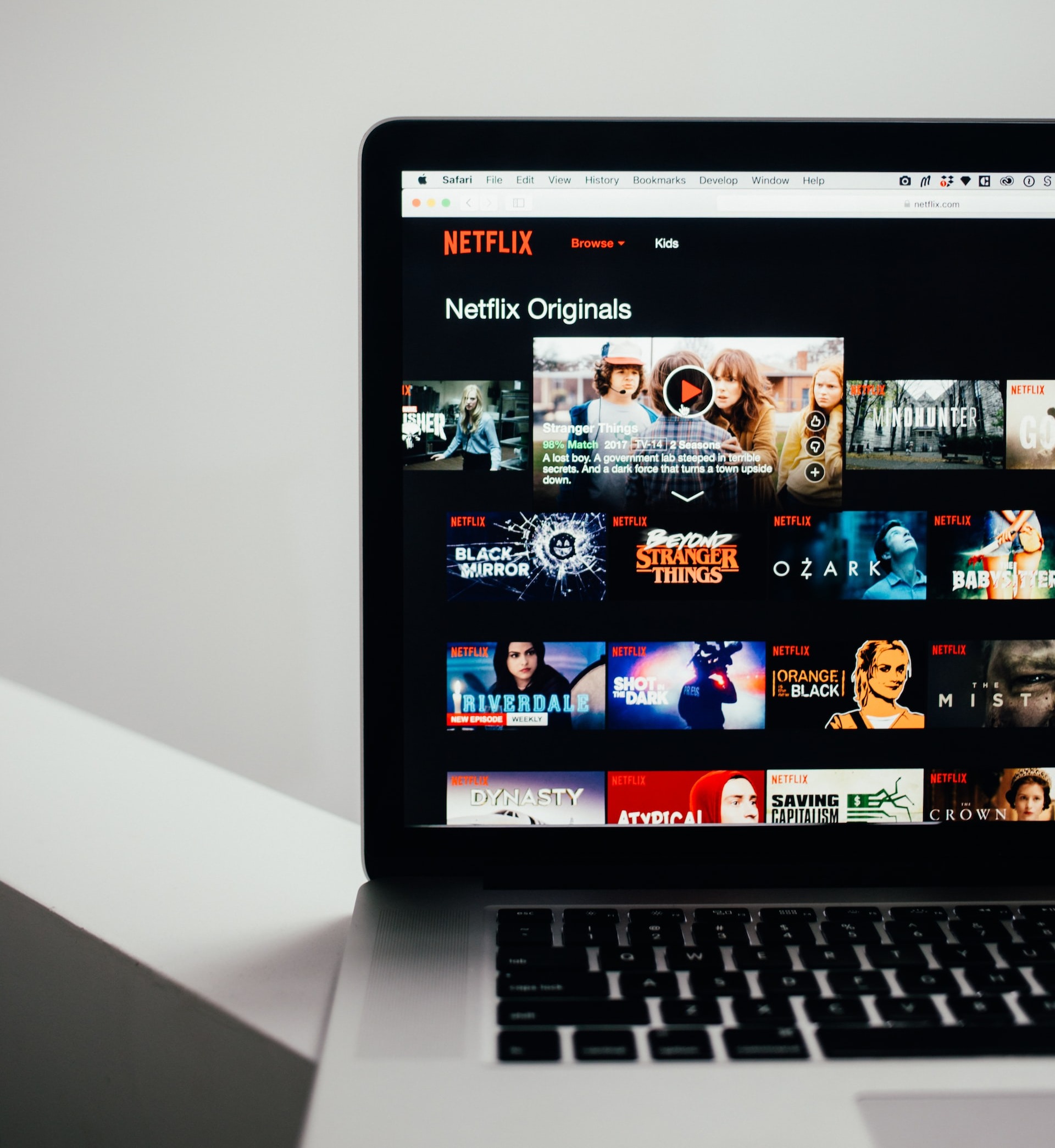 A laptop showing a list of movies and shows on  Netflix website