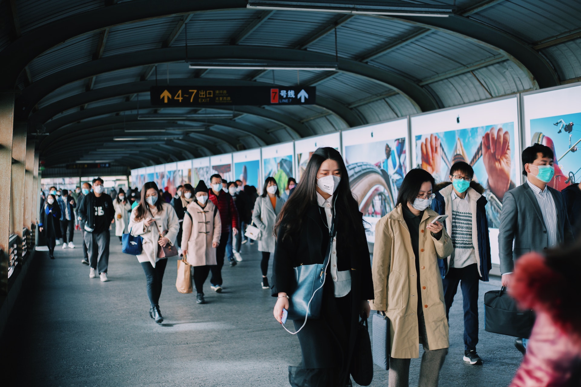 People wearing face masks at a train station