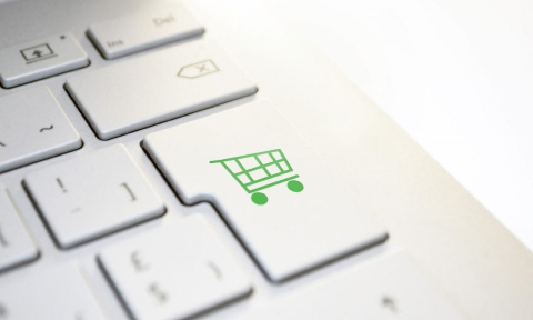Stock image of a shopping cart icon on a computer keyboard
