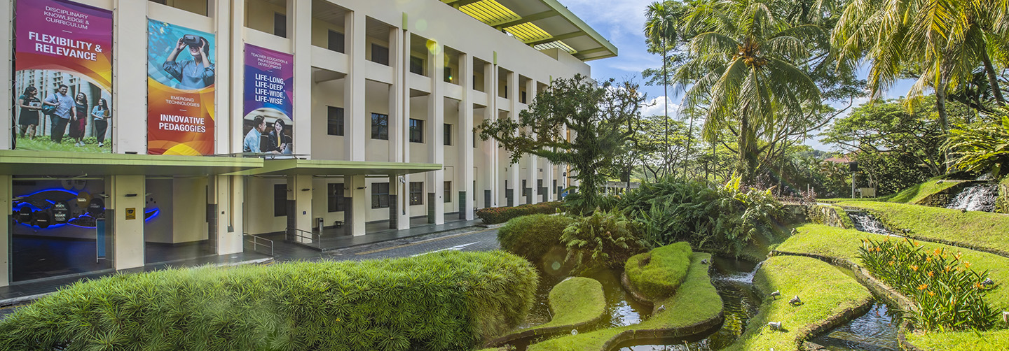 Lush Green Landscaping on NIE Campus Driveway Entrance with Building Banners