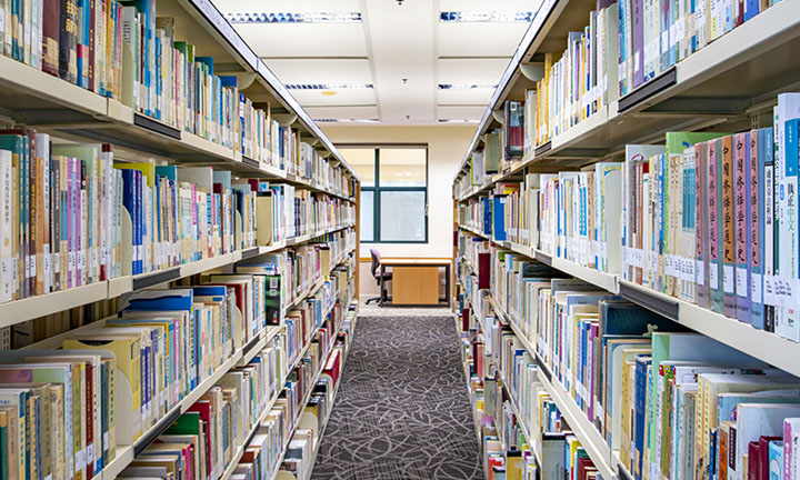 In Between Shot of Shelves of Books in a Library (720x432px)