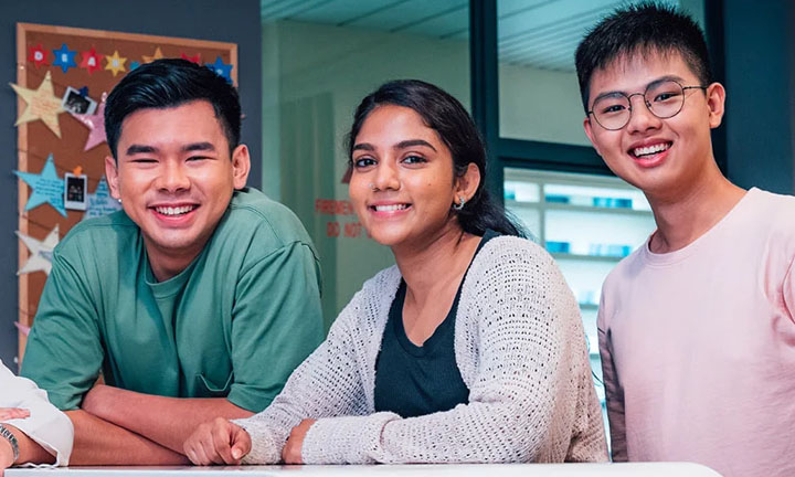 Smiling Group of 3 Young Adults Stars On Classroom Wall (720x432px)