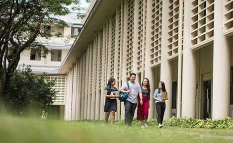 Walking Wideshot Group Of 4 Students Along NIE Campus On A Grassy Path (720x432px)