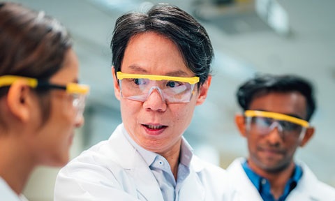 3 Scientists In Yellow Goggles In A Science Lab And Lab Coats (480x288px)