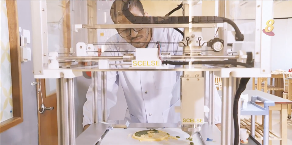 Scientist observing as food is being 3D printed