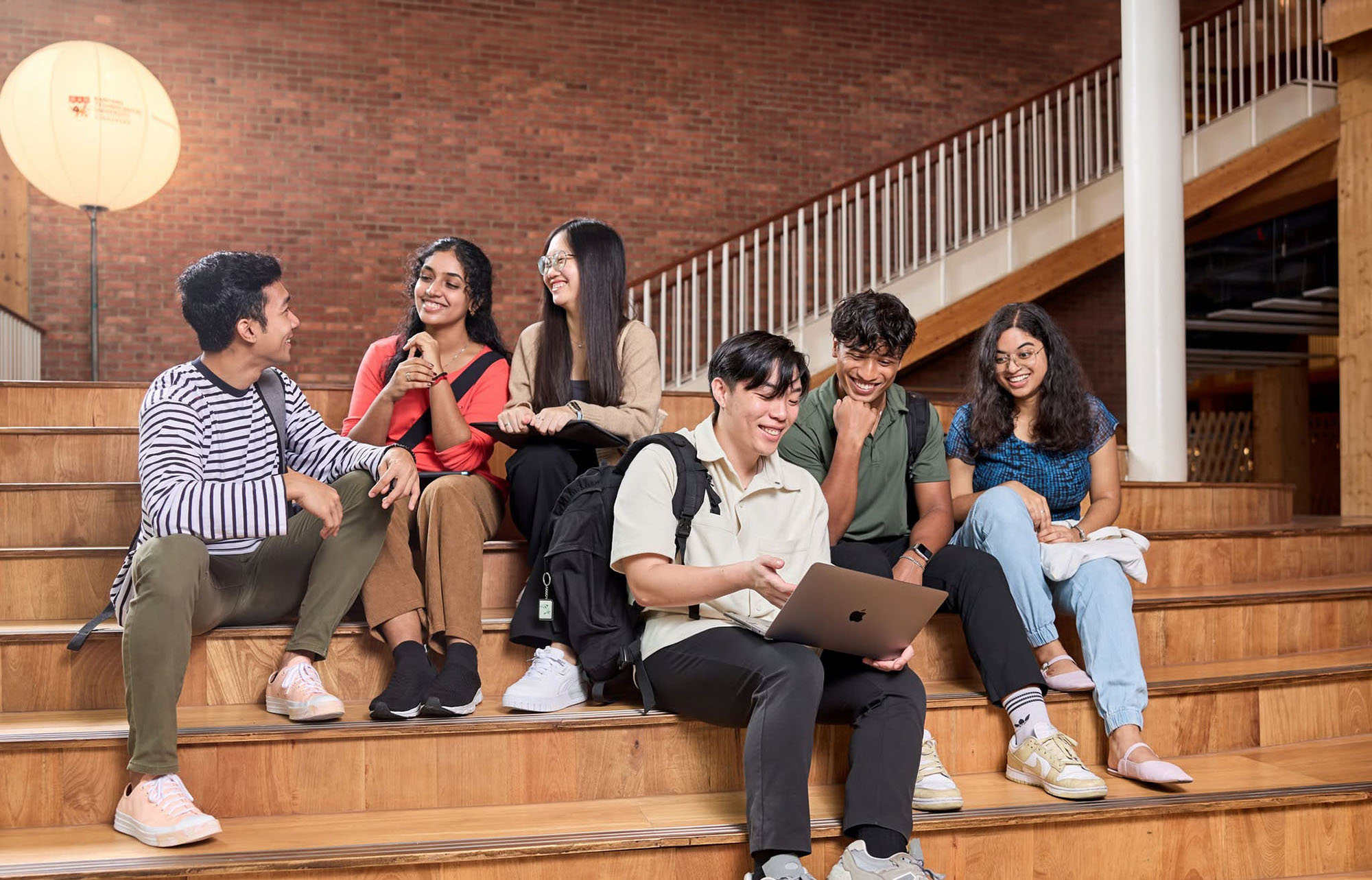 Students on tiered steps College of Humanities, Arts and Social Sciences (CoHASS)