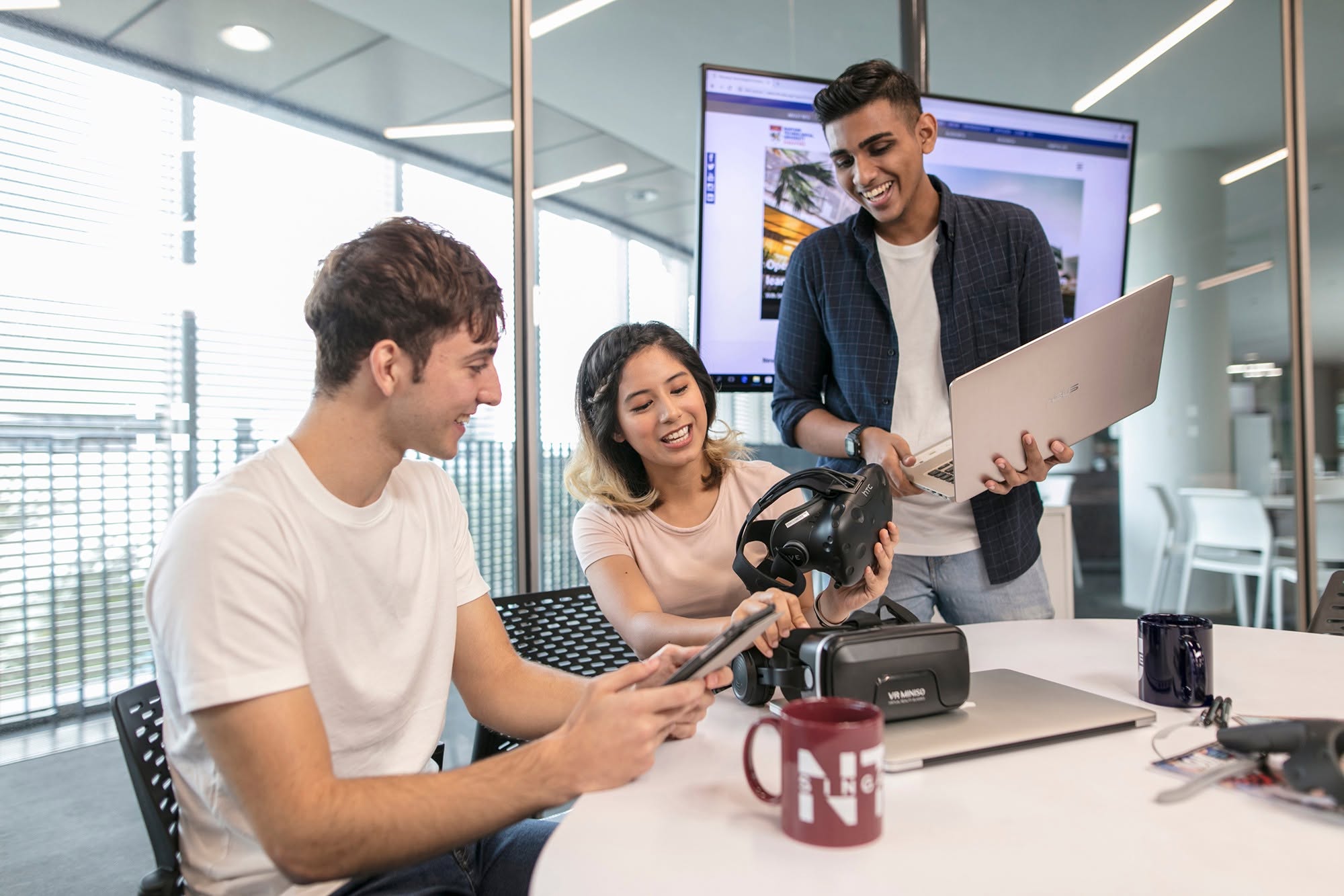 Group of NTU students discussing while holding VR devices