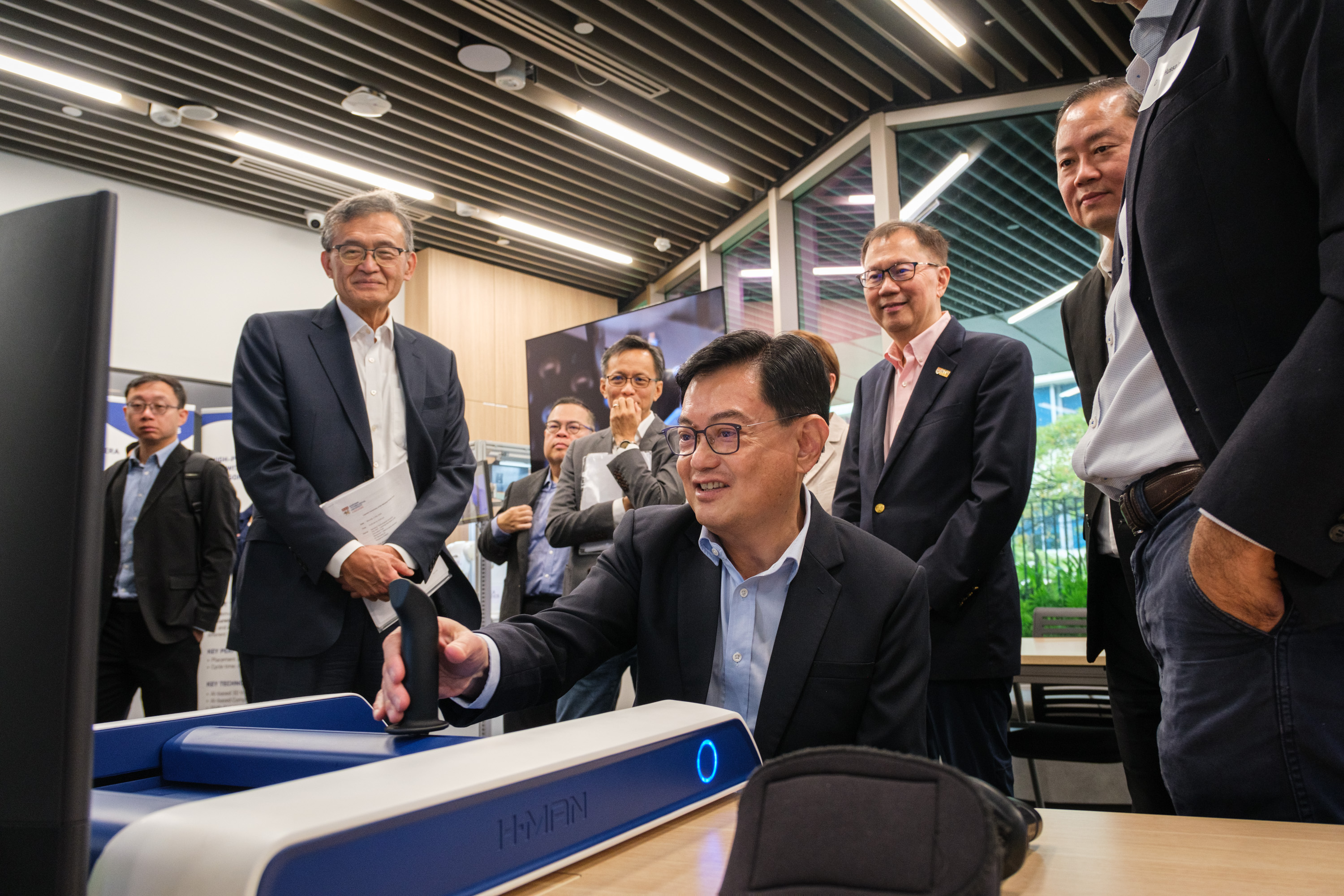 DPM Heng Swee Keat trying out the H-Man rehabilitation robot by NTU spin-off Articares