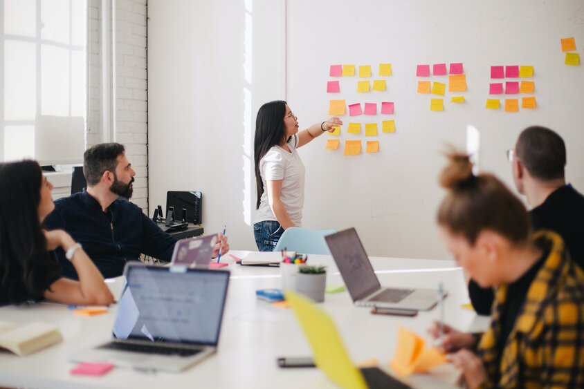 A woman presenting to her team