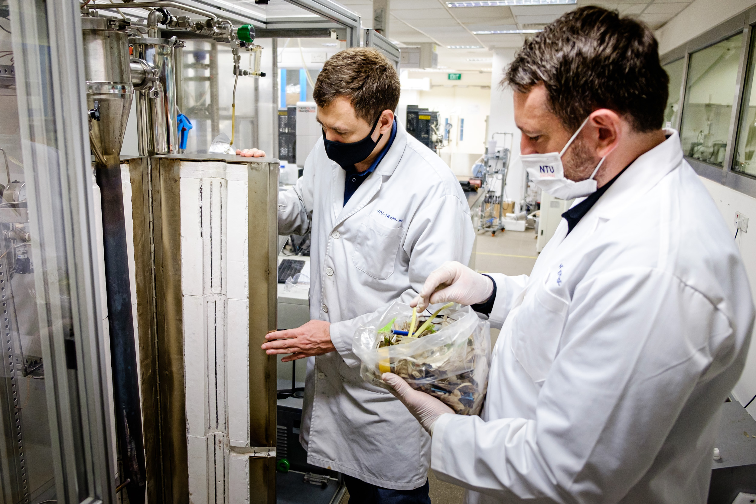 NTU Assoc Prof Grzegorz Lisak and Dr Andrei Veksha developing a pilot pyrolysis system to turn waste plastic into hydrogen and solid carbon